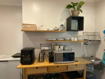 a kitchen with a wooden table with a microwave on it at BLessing at Lynnwood in Pretoria