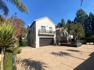 a large white house with a garage at BLessing at Lynnwood in Pretoria