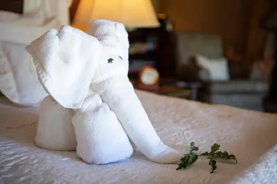 a towel elephant sitting on top of a bed at Jabulani Safari Relais & Chateaux in Kapama Private Game Reserve