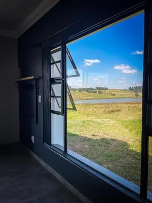 a window in a room with a view of a field at Sorgenfri farm stay in Hendrina