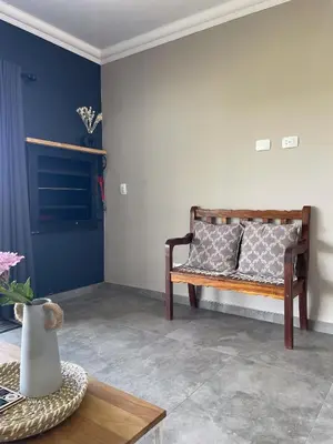 a living room with a bench with pillows on it at Sorgenfri farm stay in Hendrina