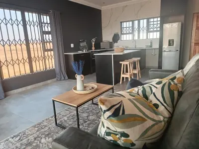 a living room with a couch and a table at Sorgenfri farm stay in Hendrina