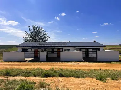 a house with solar panels on it in a field at Sorgenfri farm stay in Hendrina