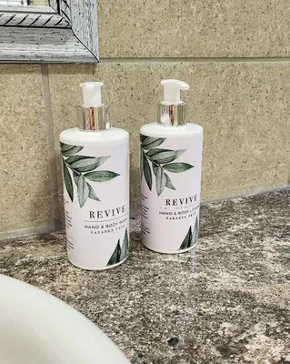 two bottles of hygiene products sitting on a counter at Waterlily Cove Guesthouse in Pretoria