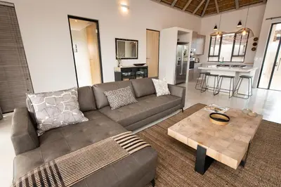 a living room with a couch and a coffee table at Villa Zazu in Hoedspruit