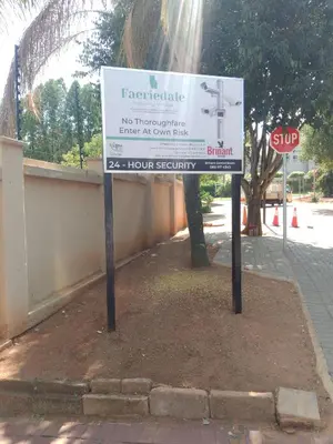 a sign on the side of a street with a stop sign at Zenith Guesthouse in Pretoria