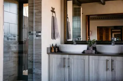a bathroom with two sinks and a mirror at Waterbuck Game Lodge Thornybush Nature Reserve in Thornybush Game Reserve
