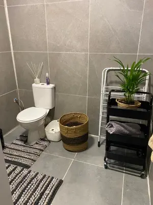 a bathroom with a toilet and a plant in it at AfricaLove on Tiger Suite in Pretoria