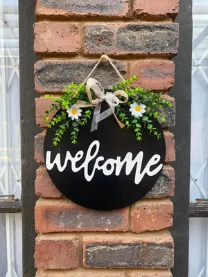 a welcome sign hanging on a brick wall at AfricaLove on Tiger Suite in Pretoria