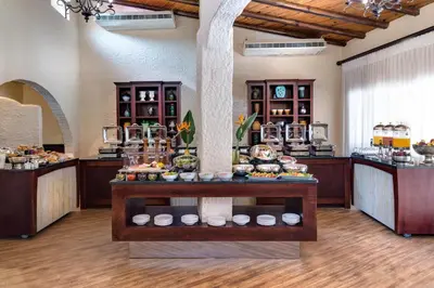 a buffet in a hotel room with food on display at Malaga Hotel in Panorama