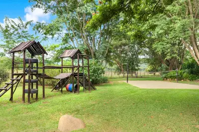 a park with a playground with a slide and swings at Malaga Hotel in Panorama