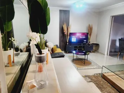 a living room with a tv and a couch at Lemon tree in Pretoria