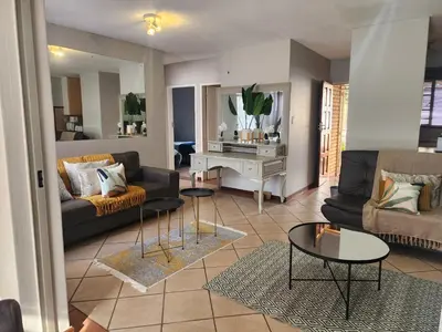 a living room with a couch and a table at Lemon tree in Pretoria