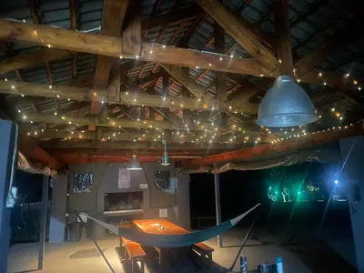 a room with a table and a ceiling with lights at Numida Rus in Marloth Park