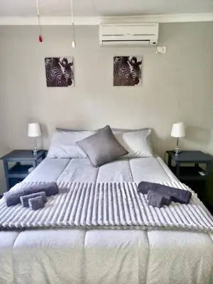 a large bed with two towels on top of it at Numida Rus in Marloth Park