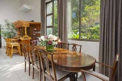 a dining room with a wooden table and chairs at Expansive 5-bedroom house in Hartbeespoort