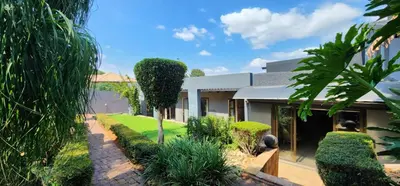 a house with a garden in front of it at Expansive 5-bedroom house in Hartbeespoort