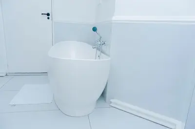 a white bathroom with a toilet and a shower at 129inHarties Lodge and SPA in Hartbeespoort