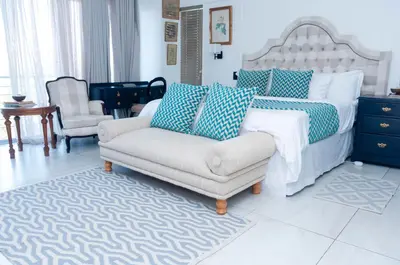 a living room with a couch and a bed at 129inHarties Lodge and SPA in Hartbeespoort