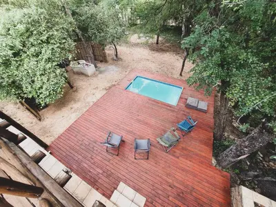 an overhead view of a swimming pool with two chairs at HUIS ASEM in Marloth Park
