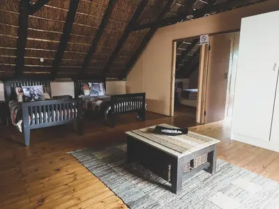 a living room with two benches and a couch at HUIS ASEM in Marloth Park