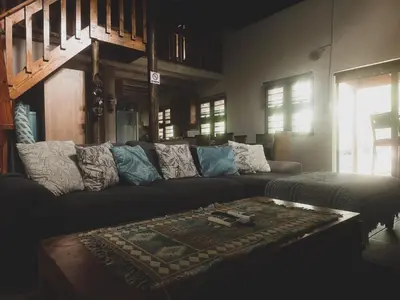 a living room with a couch and a table at HUIS ASEM in Marloth Park