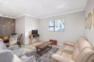 a living room with a couch and a table at Apartment at Magalies Edge in Hartbeespoort