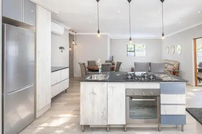 a kitchen with a sink and a stove top oven at Apartment at Magalies Edge in Hartbeespoort