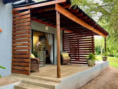 a wooden pergola on a porch of a house at Rhino Valley in Nelspruit