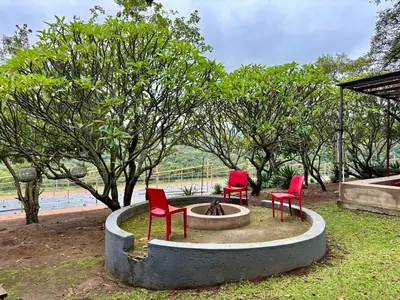 three red chairs sitting around a fire hydrant at Rhino Valley in Nelspruit