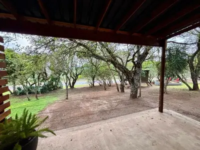 a screened porch with a view of a park at Rhino Valley in Nelspruit