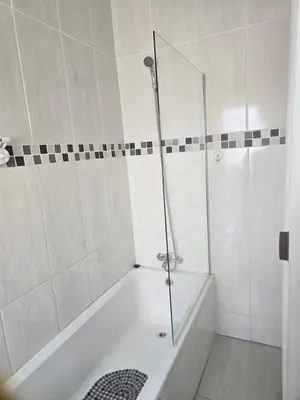 a white bathroom with a shower and a tub at Peshline Guest House Unit 1 in Ermelo