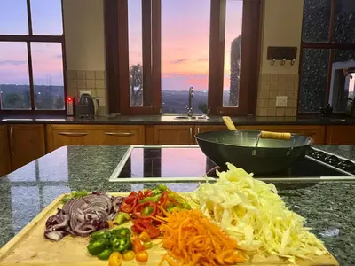 a cutting board with vegetables on a counter in a kitchen at Mountain Haven in Pretoria