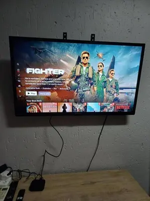 a flat screen tv hanging on a wall at Buhle Guesthouse in Sandton