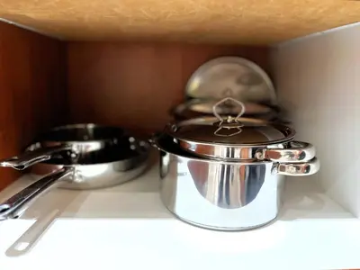 two pots and pans sitting on top of a shelf at MPASSI Properties - Hatfiled, Pretoria in Pretoria