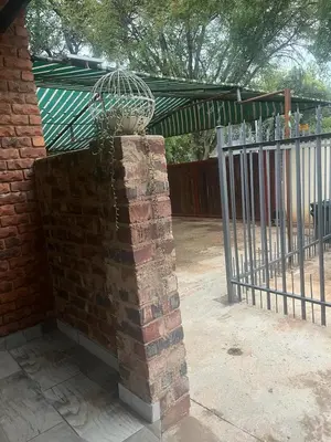 a wrought iron fence with a planter on top of it at @Eland B&B in Mokopane