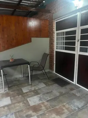 a room with a table and a chair and a window at @Eland B&B in Mokopane