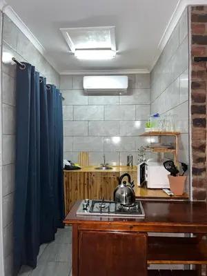 a kitchen with a stove with a tea kettle on it at @Eland B&B in Mokopane