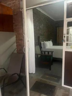 a room with a bedroom with a bed and a window at @Eland B&B in Mokopane