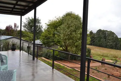 a screened porch with a view of a field at Mika Self Catering Cottage in Dullstroom