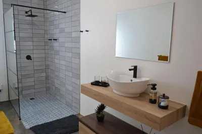 a bathroom with a sink and a shower at Mika Self Catering Cottage in Dullstroom