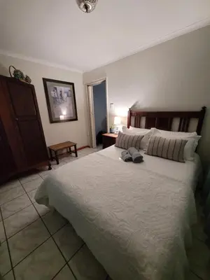 a bedroom with a large white bed in a room at Dutch on Tecoma, Wonderboom, Pretoria in Pretoria