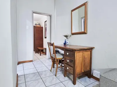 a room with a desk and a mirror on a wall at Dutch on Tecoma, Wonderboom, Pretoria in Pretoria