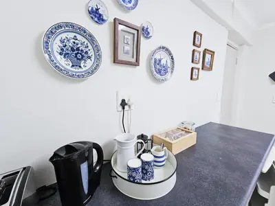 a table with blue and white plates on the wall at Dutch on Tecoma, Wonderboom, Pretoria in Pretoria