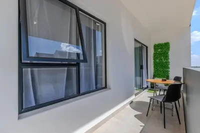 a room with windows and a table and chairs at The Resting Nest Delight in Midrand