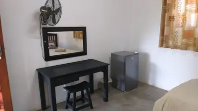 a black desk in a room with a mirror at Paperbark Self Catering Units in Doornfontein
