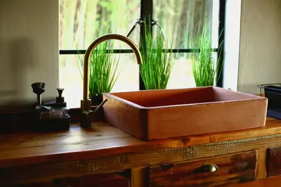 a copper sink on top of a wooden counter at Frere Guesthouse in Ermelo