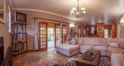 a living room with a couch and a table at Tuareg Guest House in Midrand