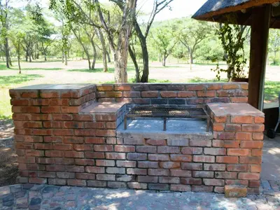 an outdoor brick oven in a park at Masungulo Lodge in Modimolle