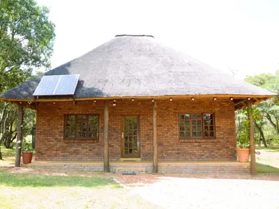 a house with a roof with a solar panel on it at Masungulo Lodge in Modimolle